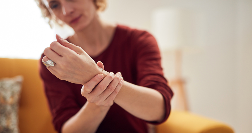 Woman holding rheumatoid hand